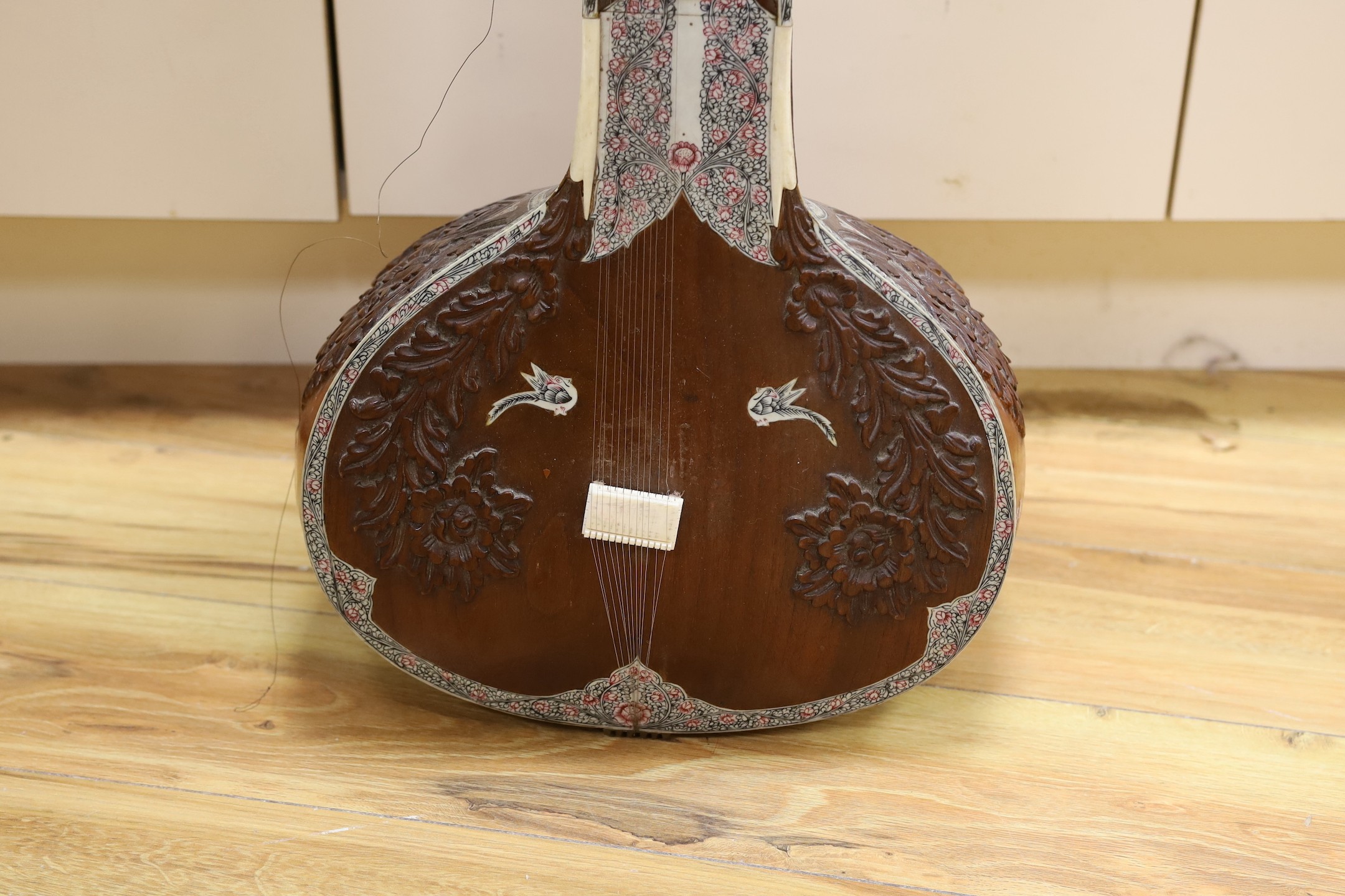 A sitar with wooden carved decoration
